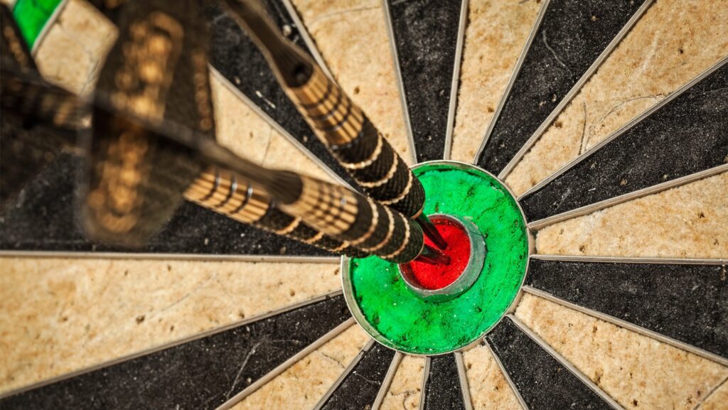 Three darts in bull's eye close up